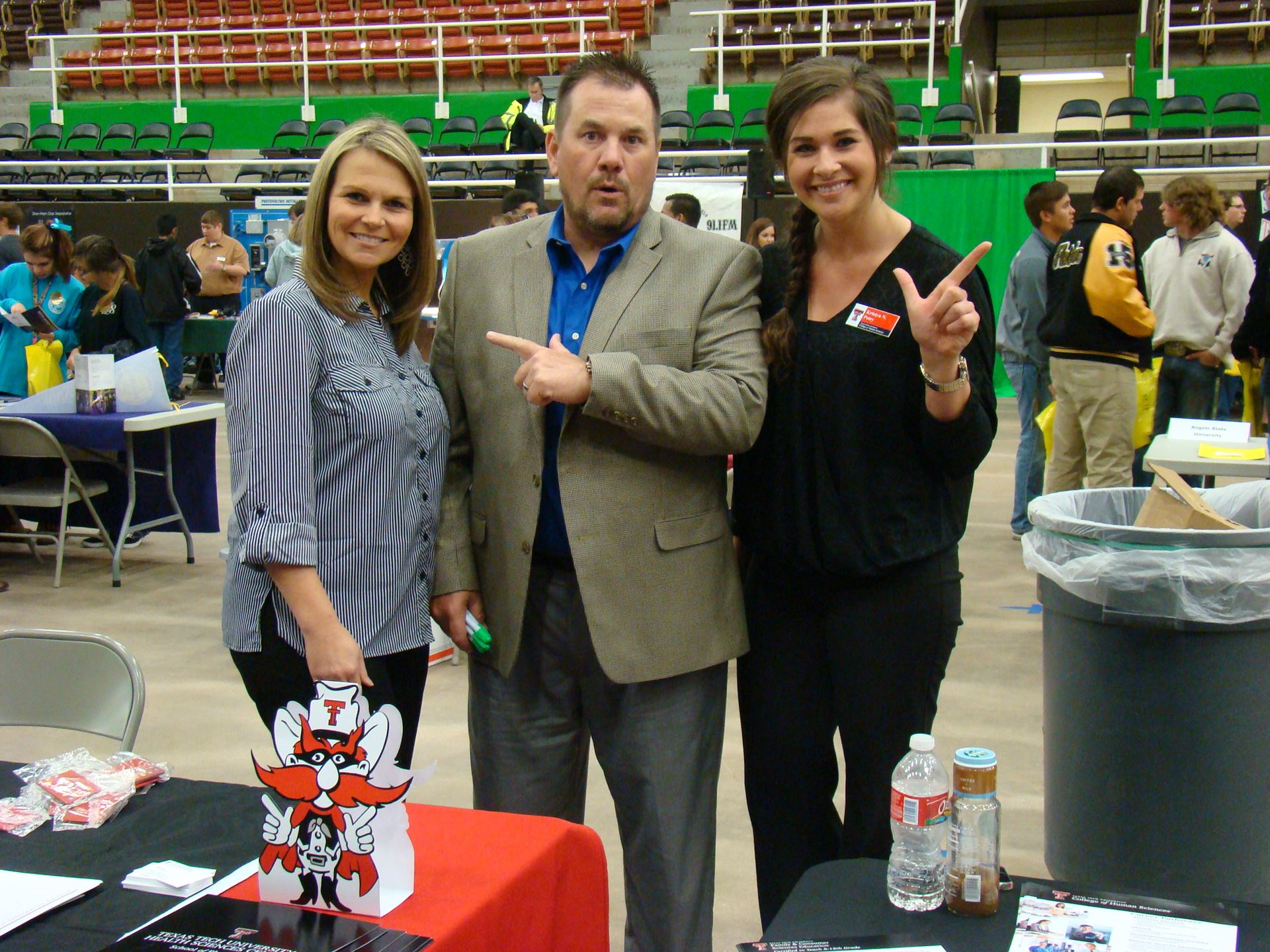 Individuals pose in support of Texas Tech Red Raiders.